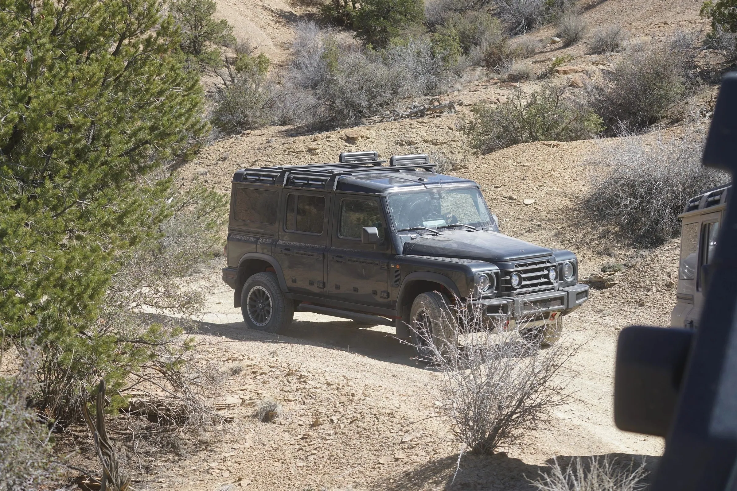 Dark 4x4 on a sandy trail through sagebrush
