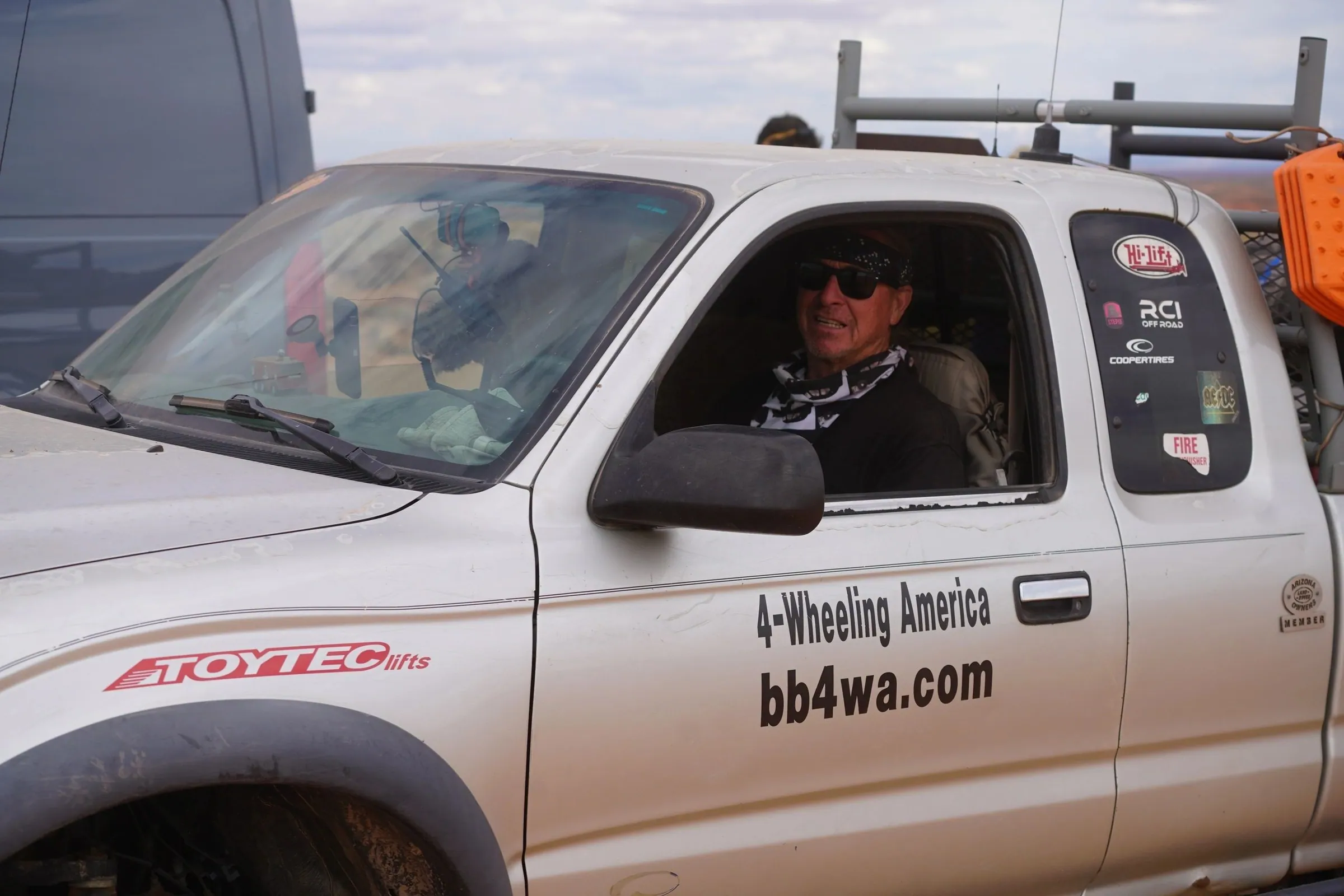 Smiling driver looking out of a pickup truck window